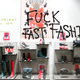 The slogan "Fuck Fast Fashion" is seen on a shop window as Youth for Climate activists demonstrate inside the Westfield Les 4 Temps shopping center as part of a day of protest to denounce the annual Black Friday shopping frenzy at La Defense business and financial district in Puteaux near Paris